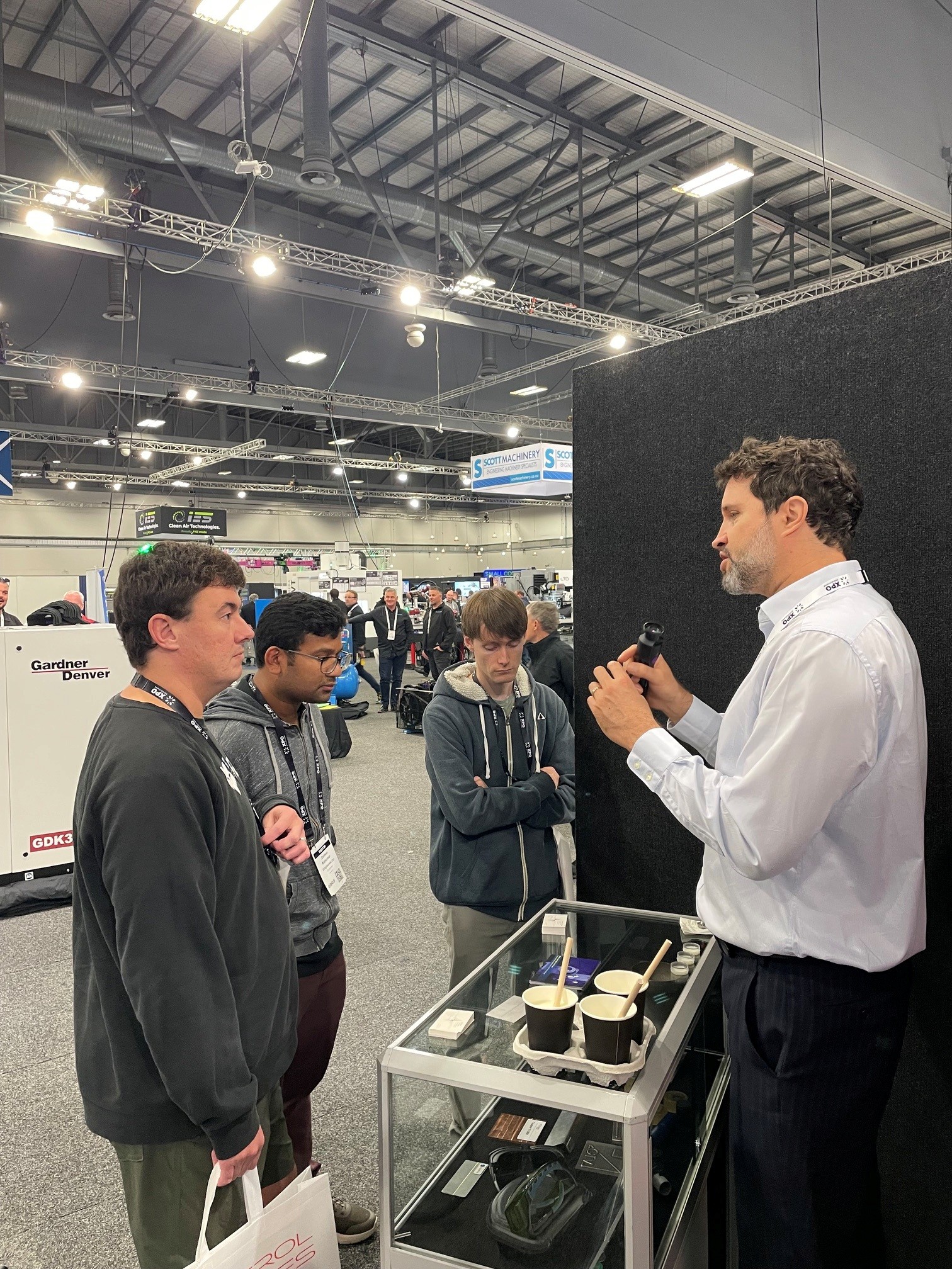 Dr Cédric Chaminade showing the Viavi MicroNIR spectrometer to visitors to the Raymax stand at EMEX 2026